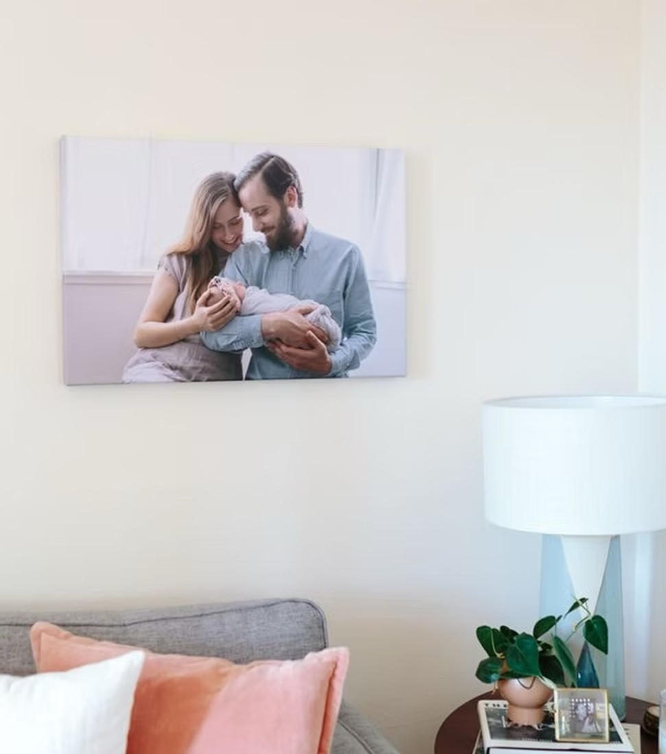 A canvas print of new parents holding their baby