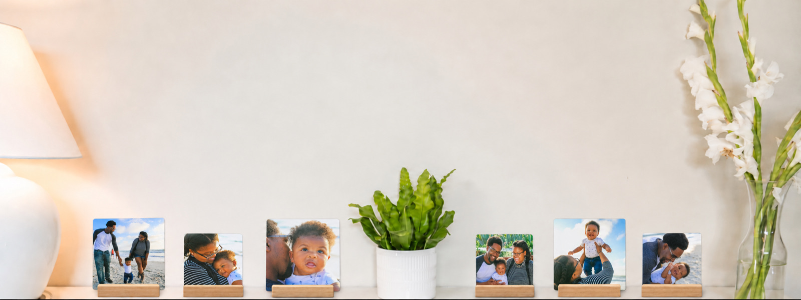 Six family desk prints, in both sizes, along a shelf