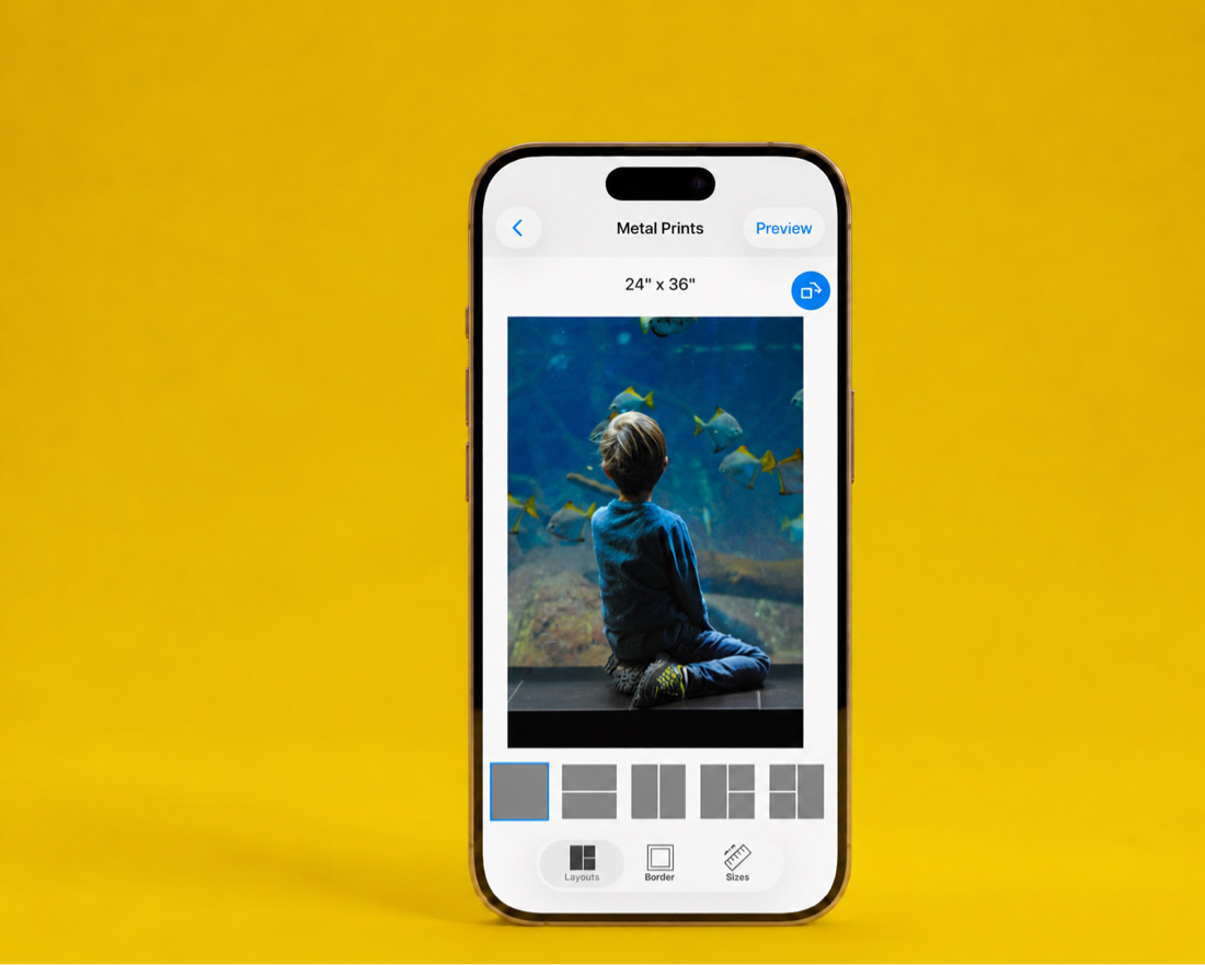 The SimplePrints app showing a 24×36 metal print of a boy watching fish at an aquarium