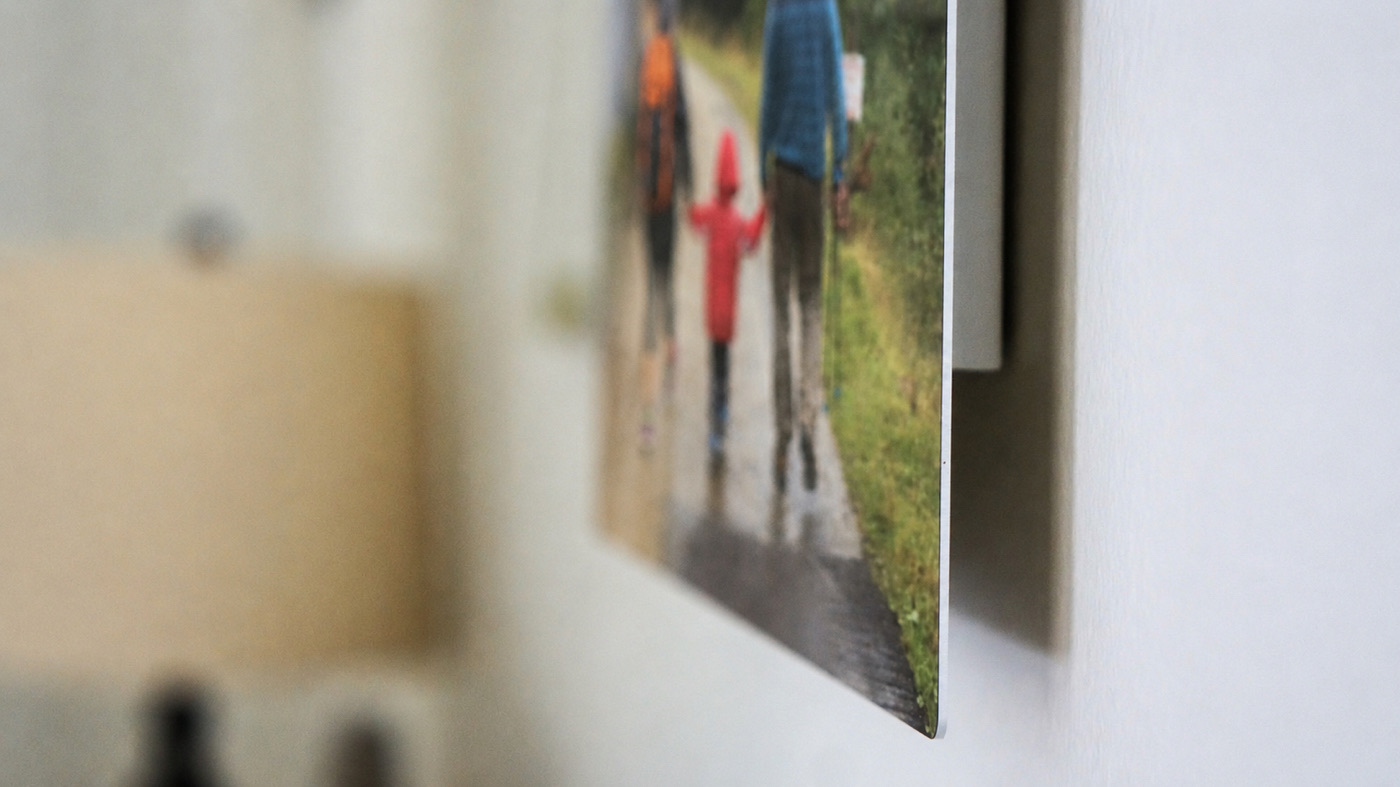 Close-up of a family metal print of a walk in the rain, floating off the wall on its recessed float mount