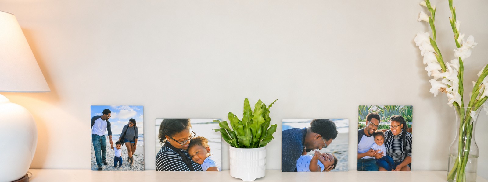 Four family metal prints in different sizes along a shelf