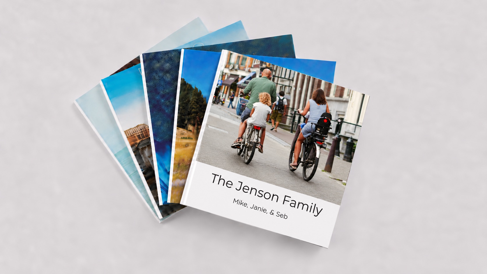 A fan of family photo books, the top one titled The Jenson Family