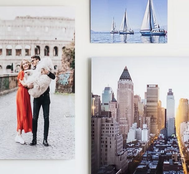 Metal prints of a couple in Rome, sailboats and a city skyline on a white wall