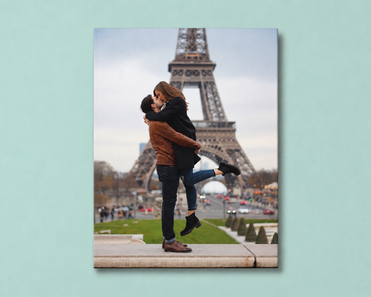 A travel canvas print of a couple kissing in front of the Eiffel Tower