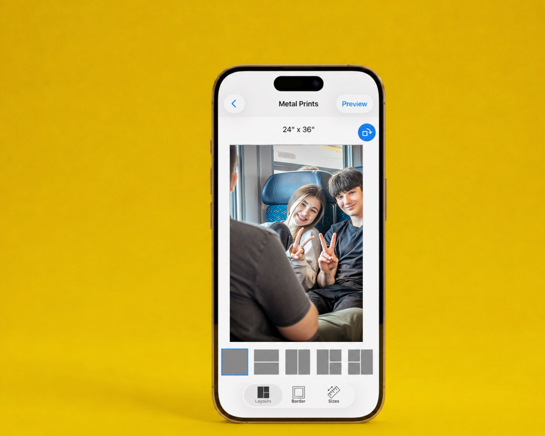 The SimplePrints app showing a 24×36 metal print of two friends on a train