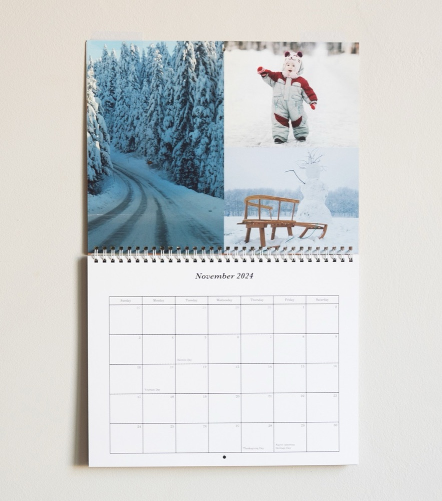 A wall calendar open to November, with three winter photos above the month